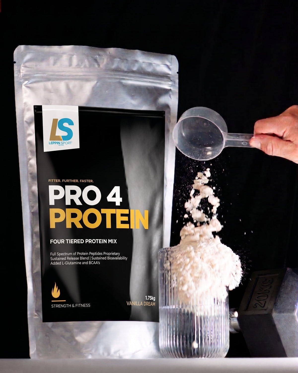 A silver stand-up pouch of LS Pro 4 Bulk four-tiered protein mix is shown on a black background, with a hand holding a scoop pouring white powder into a clear glass container.